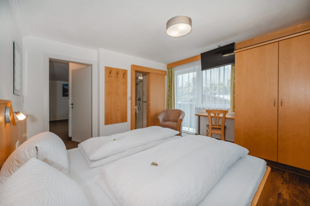 Appartement Grafenberg 2 - Schlafraum 1 mit Doppelbett und eigene Dusche / WC. Flat TV und Balkon mit Blick auf Wagrain